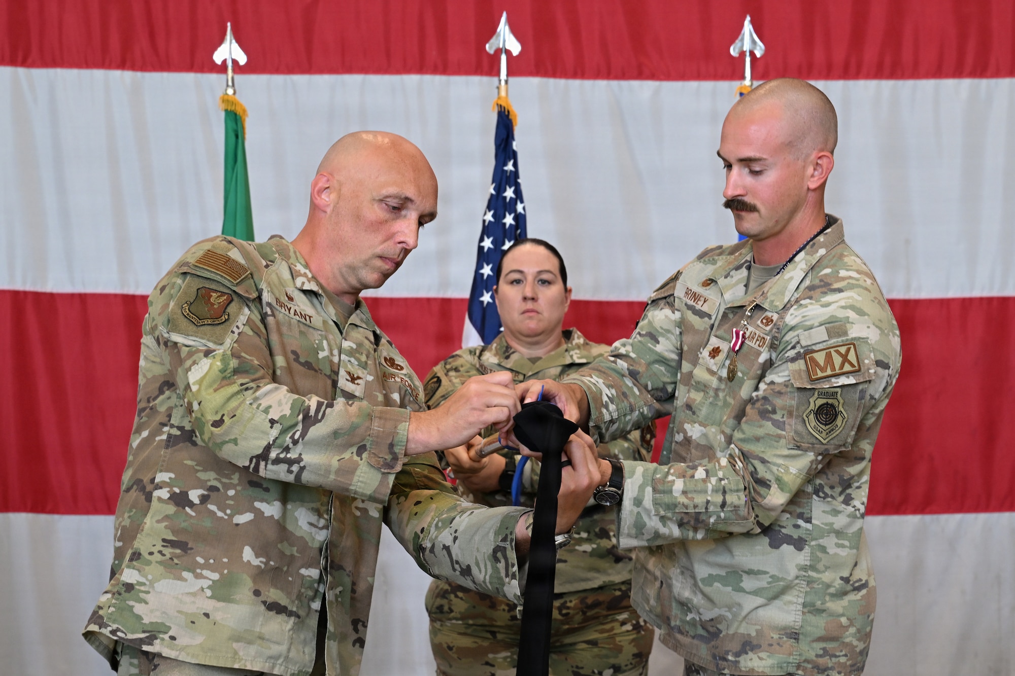 Commander Bryant and Briney cases the 510th Squadron guidon flag.