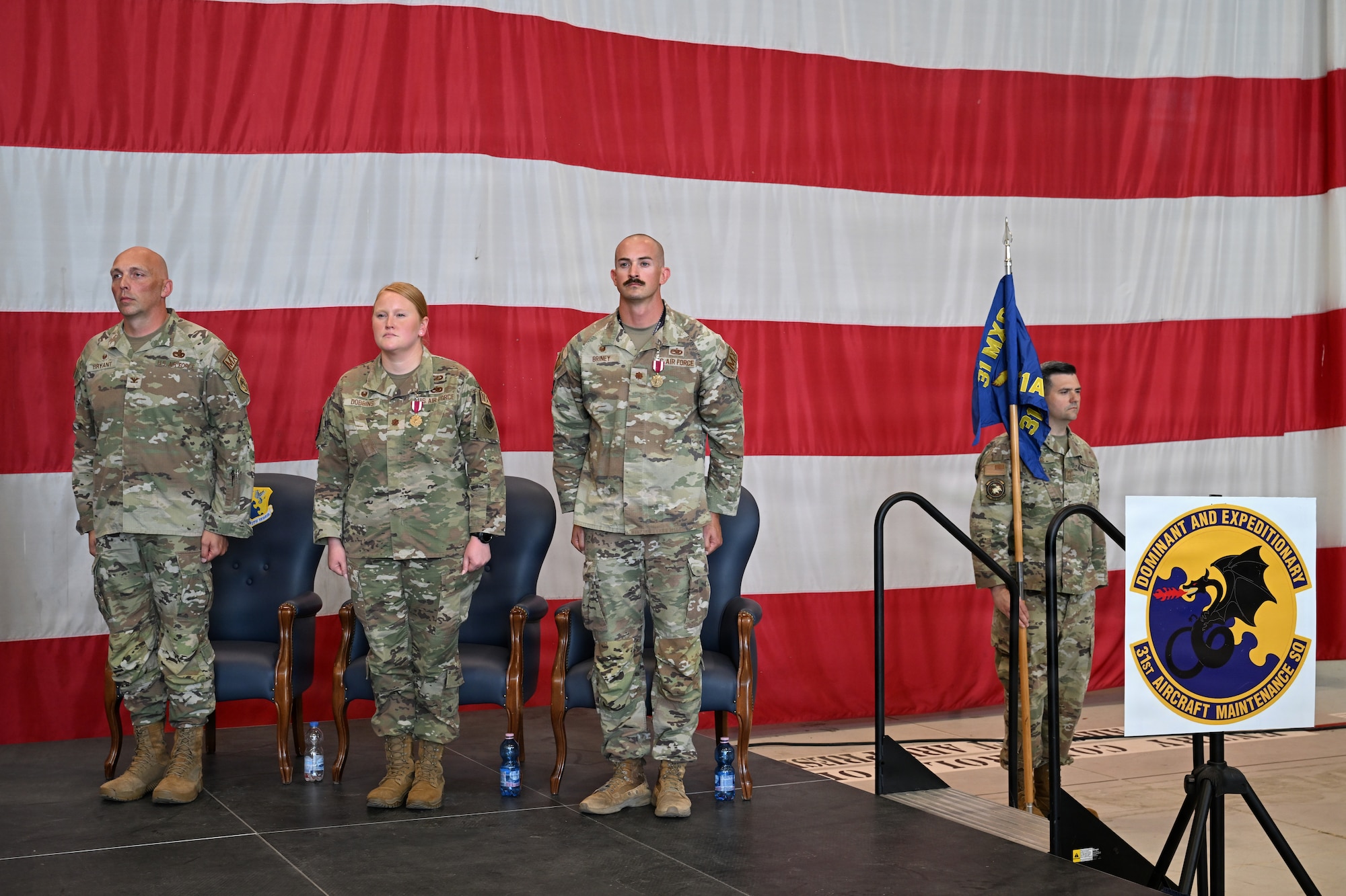 Commanders stands at attention during the end of ceremony.