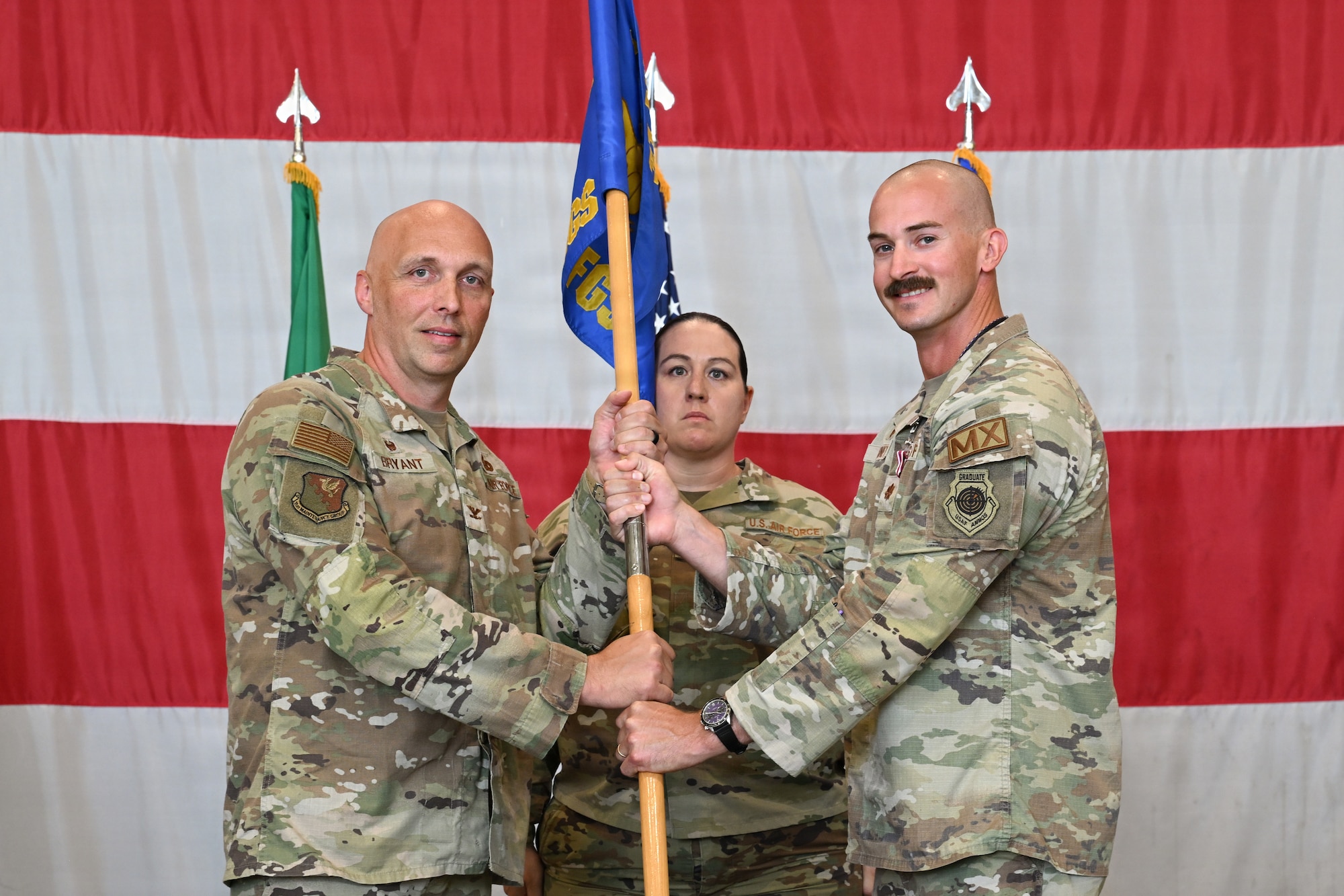 Commander Bryant and Briney holds the guidon.