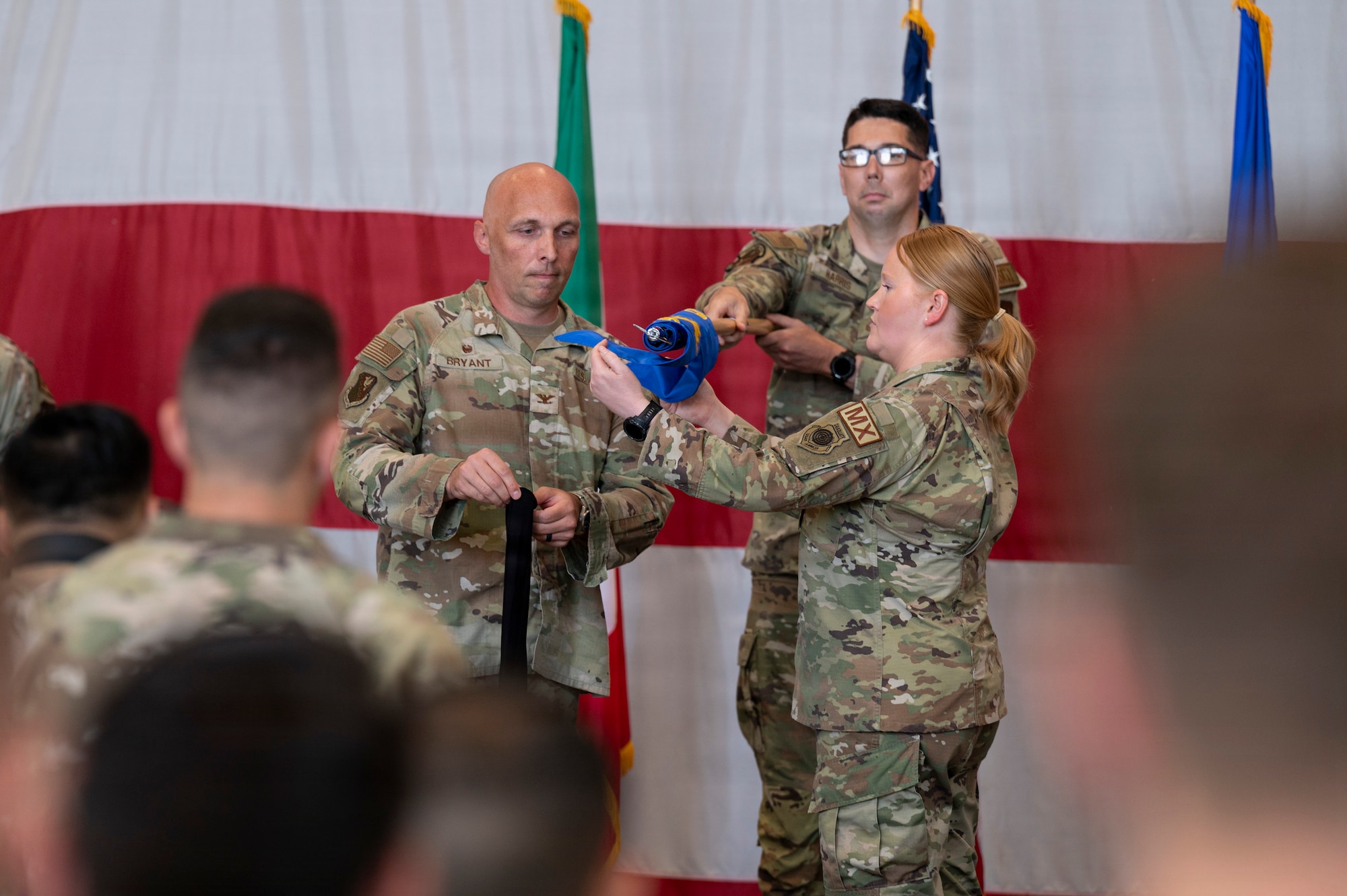 Commander Bryant and Dobbins covers the 56th Squadron guidon.