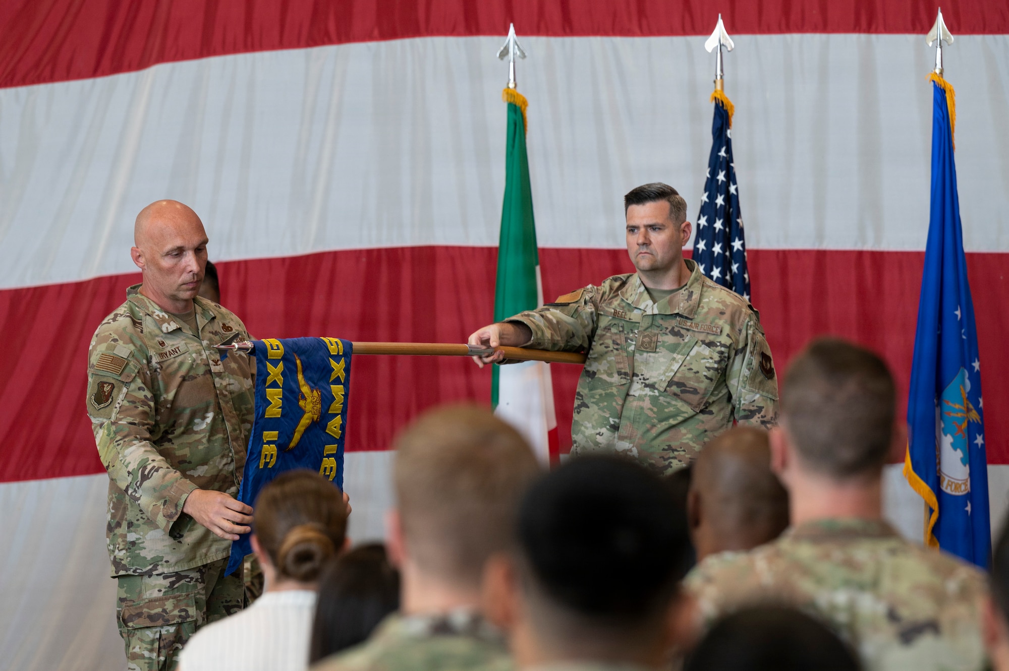 Commander Bryant uncovers the new guidon flag.