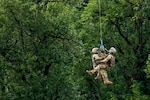 Two Oregon Army National Guard Flight Medics assigned to G Company, 1-189th Aviation Regiment, are hoist lifted back aboard an HH60M Black Hawk while working with Clackamas Fire Department responders and Air Force Reserve Pararescuemen from the 304th Rescue Squadron, during joint training along the Sandy River at Dodge Park in Sandy, Oregon, on June 5, 2026.