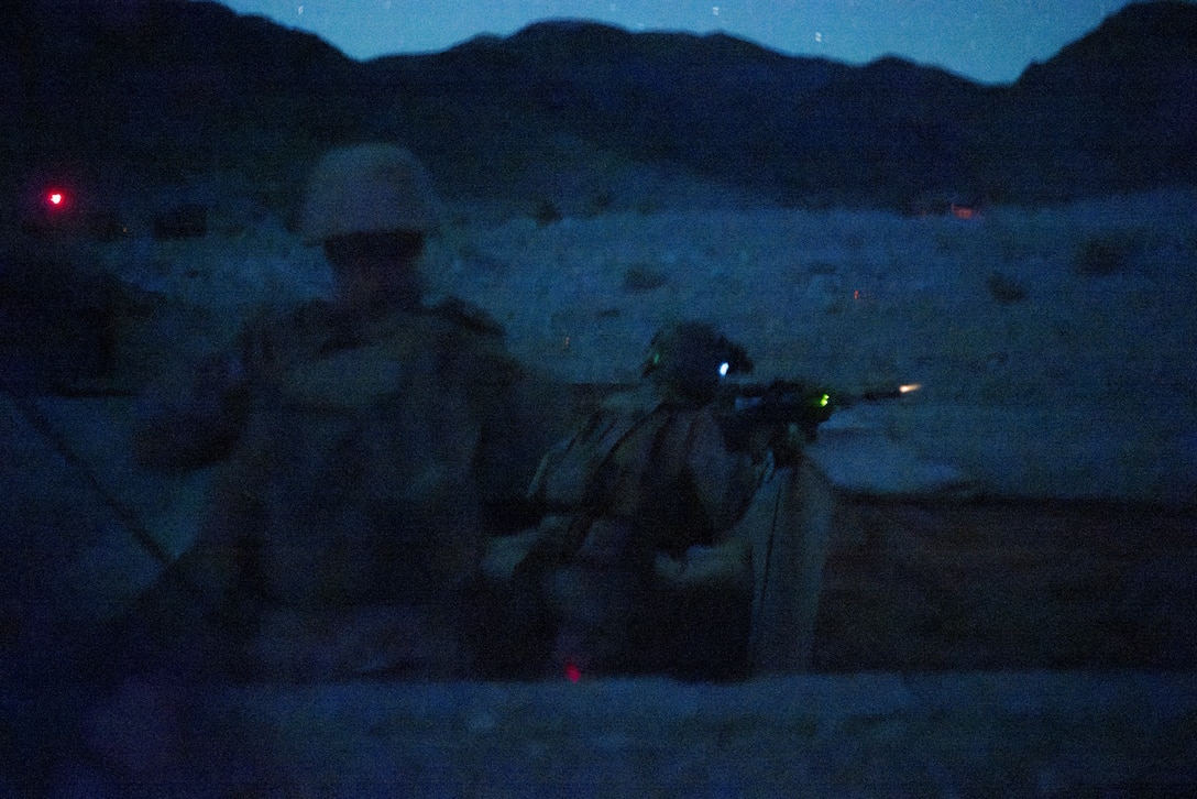 A U.S. Marine with 1st Battalion, 24th Marines, 4th Marine Division, fires an M27 infantry automatic rifle at simulated enemy targets during a live fire night platoon attack on Range 410 Alpha as part of Integrated Training Exercise 3-26, Marine Corps Air Ground Combat Center Twentynine Palms, California, June 7, 2026. ITX is designed to generate combat readiness and ensure the Reserve Component provides critical strategic depth to the Total Force. From complex combined arms maneuvers to all-domain integration, these Marines are proving that they are ready to augment, reinforce, and fight alongside the active component at a moment's notice. (U.S. Marine Corps photo by Cpl. Van Hoang)