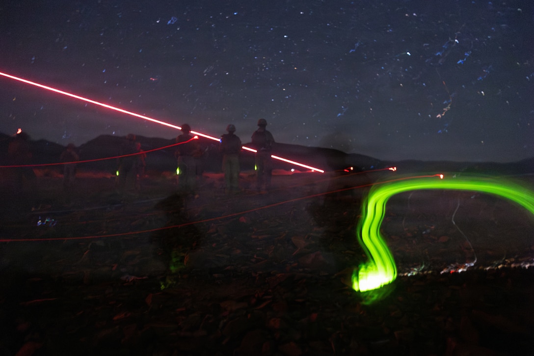 Service level training instructors with Tactical Training and Exercise Control Group, Marine Air Ground Task Force Training Command, Marine Corps Air Ground Combat Center, assess Marines with 1st Battalion, 24th Marines, 4th Marine Division, during a live fire night platoon attack on Range 410 Alpha as part of Integrated Training Exercise 3-26, Marine Corps Air Ground Combat Center Twentynine Palms, California, June 7, 2026. ITX is designed to generate combat readiness and ensure the Reserve Component provides critical strategic depth to the Total Force. From complex combined arms maneuvers to all-domain integration, these Marines are proving that they are ready to augment, reinforce, and fight alongside the active component at a moment's notice. (U.S. Marine Corps photo by Cpl. Kanoa Thomas)