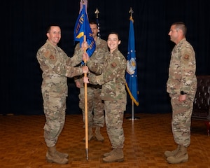 a person passes a flag to another person on a stage