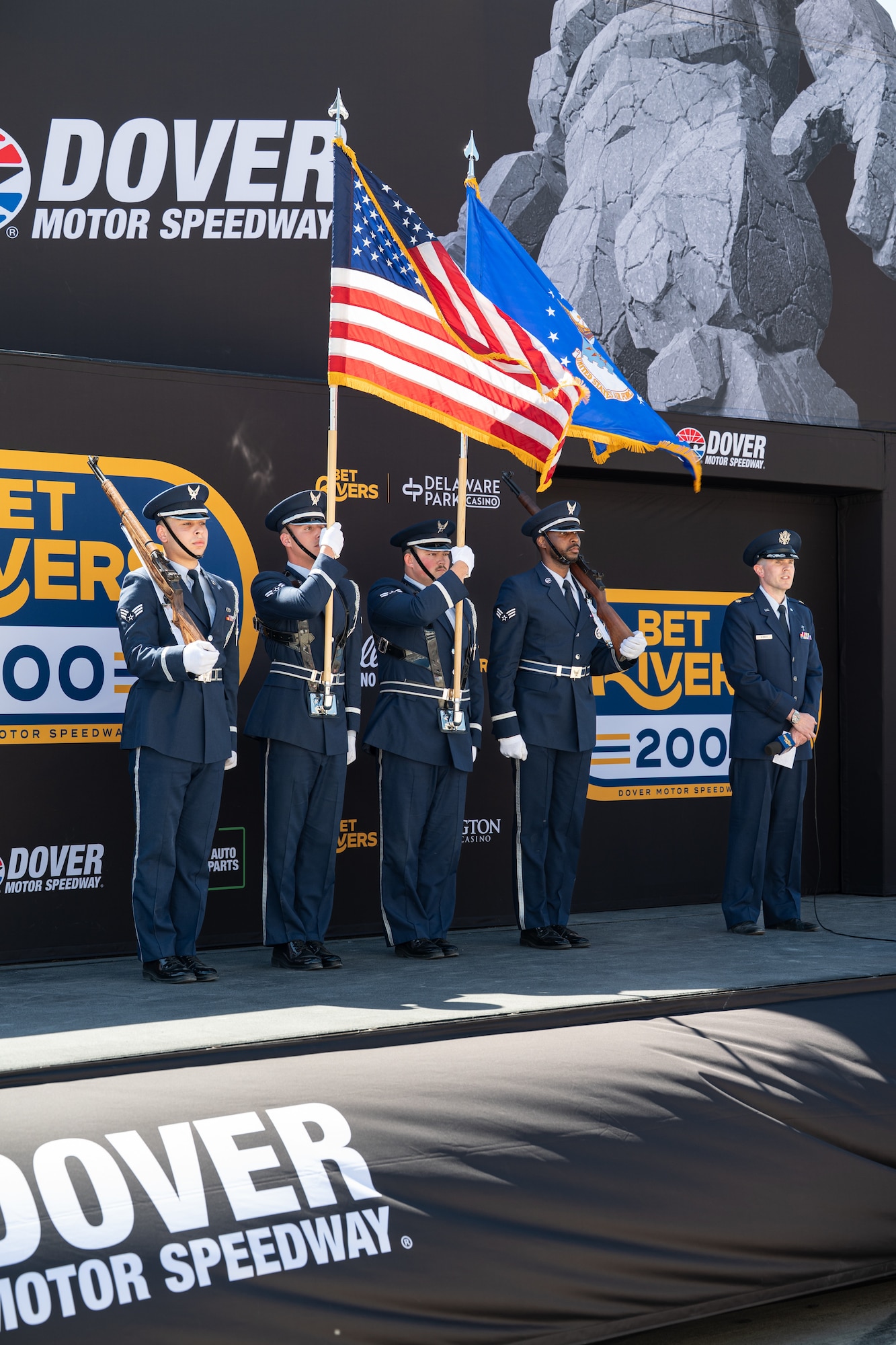 Members of the 436th Airlift Wing Honor Guard present the colors at the Dover Motor Speedway in Dover, Delaware, May 16, 2026. During the second day of opening weekend, Dover Air Force Base Honor Guard, chaplain and national anthem singer performed in front of a large crowd both in person and virtually. (U.S. Air Force photo by Airman 1st Class Macy Dismore-Mann)
