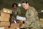 U.S. Army Reserve Spc. Melissa Rosales, right, and Pfc. Jeramaya Wilson, both automated logistical specialists assigned to the St. Charles, Mo., based 332nd Medical Company (Logistics), store medical equipment during the pre-check inventory packing, or PCIP, with the Theater Lead Agent for Medical Materiel, or TLAMM, warehouse, at JBSA-Kelly Field Annex in San Antonio, May 7, 2026. PCIPs with the TLAMM ensure individual and collective unit readiness by having Soldiers accurately pinpoint logistical requirements prior to training exercises and real-world operations. (U.S. Army Reserve photo by Sgt. 1st Class Christopher A. Hernandez)