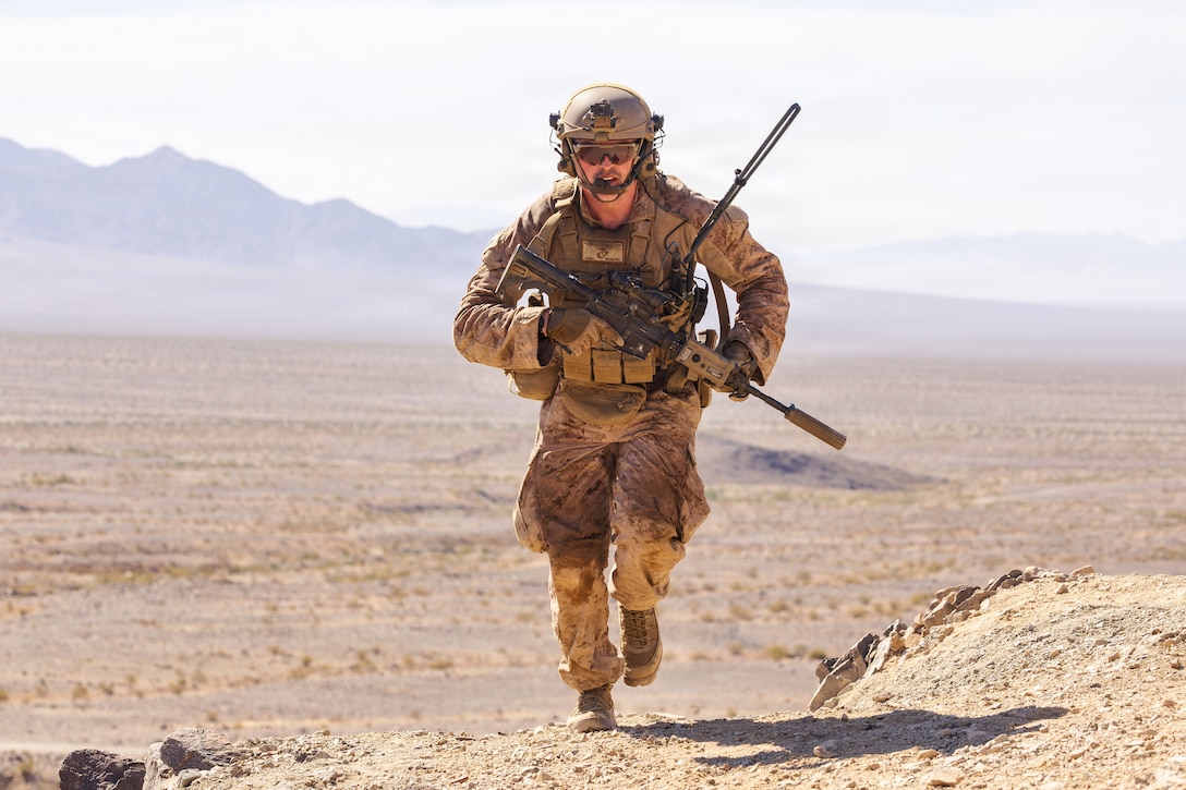 U.S. Marine Corps Sgt. Dylan Rutan, a machine gun section leader with 1st Battalion, 24th Marine Regiment, 4th Marine Division, runs to a machine gun position during a live fire platoon attack on Range 410 Alpha as part of Integrated Training Exercise 3-26, Marine Corps Air Ground Combat Center Twentynine Palms, California, June 7, 2026. ITX is designed to generate combat readiness and ensure the Reserve Component provides critical strategic depth to the Total Force. From complex combined arms maneuvers to all-domain integration, these Marines are proving that they are ready to augment, reinforce, and fight alongside the active component at a moment's notice. (U.S. Marine Corps photo by Cpl. Van Hoang)