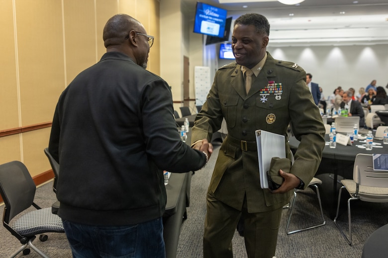 U.S. Marine Corps Col. Gregory Pace, right, commanding officer, Marine Corps Installations East–Marine Corps Base Camp Lejeune, greets a community member during the 2026 State of the Community Luncheon at the Onslow County Government Center, in Jacksonville, North Carolina, June 4, 2026. This event highlighted the importance of collaboration between military, local government, businesses and community organizations. (U.S. Marine Corps Photo by Cpl. Jessica J. Mazzamuto)