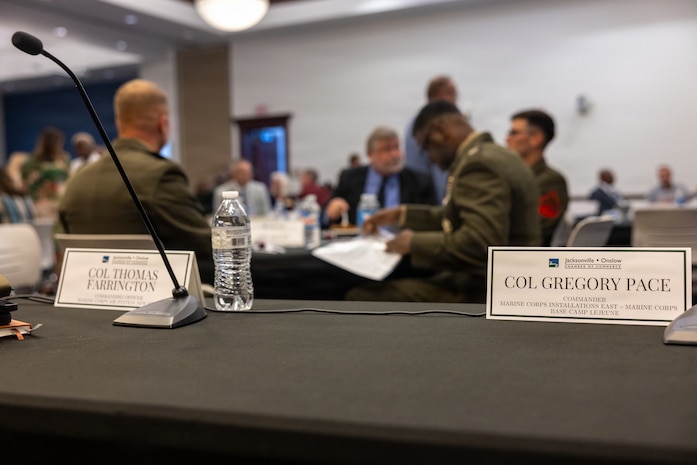Name placards for U.S. Marine Corps Col. Gregory Pace, commanding officer, Marine Corps Installations East–Marine Corps Base Camp Lejeune, and Col. Thomas C. Farrington II, commanding officer, Marine Corps Air Station New River, at the 2026 State of the Community Luncheon at the Onslow County Government Center, in Jacksonville, North Carolina, June 4, 2026. This event highlighted the importance of collaboration between military, local government, businesses and community organizations. (U.S. Marine Corps Photo by Cpl. Jessica J. Mazzamuto)