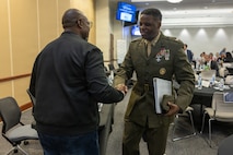 U.S. Marine Corps Col. Gregory Pace, right, commanding officer, Marine Corps Installations East–Marine Corps Base Camp Lejeune, greets a community member during the 2026 State of the Community Luncheon at the Onslow County Government Center, in Jacksonville, North Carolina, June 4, 2026. This event highlighted the importance of collaboration between military, local government, businesses and community organizations. (U.S. Marine Corps Photo by Cpl. Jessica J. Mazzamuto)