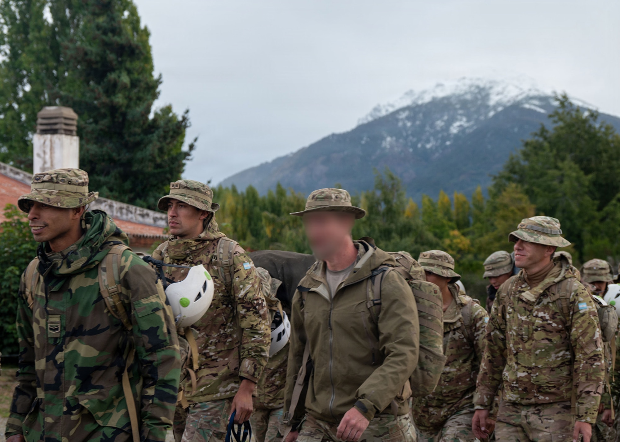 U.S. Airmen from the 919th SOW and 492nd SOW and Argentinean military members march in formation at the Escuela Militar de Montaña in Bariloche, Argentina.