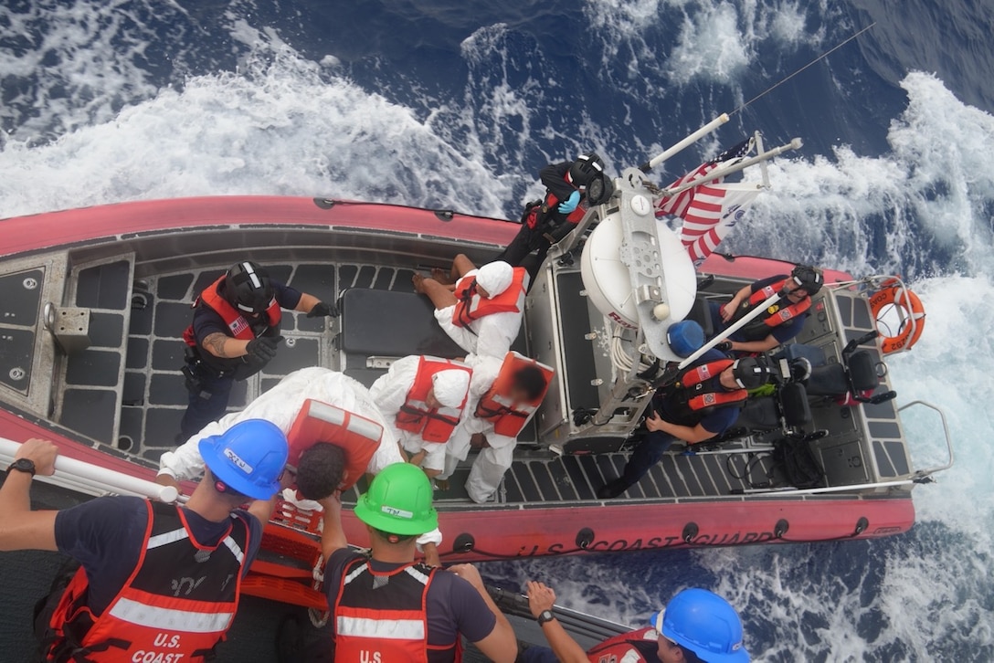 Coast Guard Cutter Heriberto Hernandez's crew disembarks a group of people to the cutter's small boat before being transferred to a Dominican Republic Navy vessel, June 7, 2026, during the repatriation of 32 aliens who were interdicted by the cutter a day earlier off Desecheo, Puerto Rico.  The interdiction is part of Homeland Security Task Force – San Juan Region efforts to combat human smuggling and deter unlawful maritime migration.(U.S. Coast Guard photo)