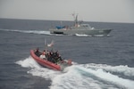 Coast Guard Cutter Heriberto Hernandez's small boat transfers a group of people during the repatriation of 32 aliens to a Dominican Republic Navy vessel, June 7, 2026.  The aliens were interdicted a day earlier off Desecheo, Puerto Rico, as part  of Homeland Security Task Force – San Juan Region efforts to combat human smuggling and deter unlawful maritime migration.(U.S. Coast Guard photo)