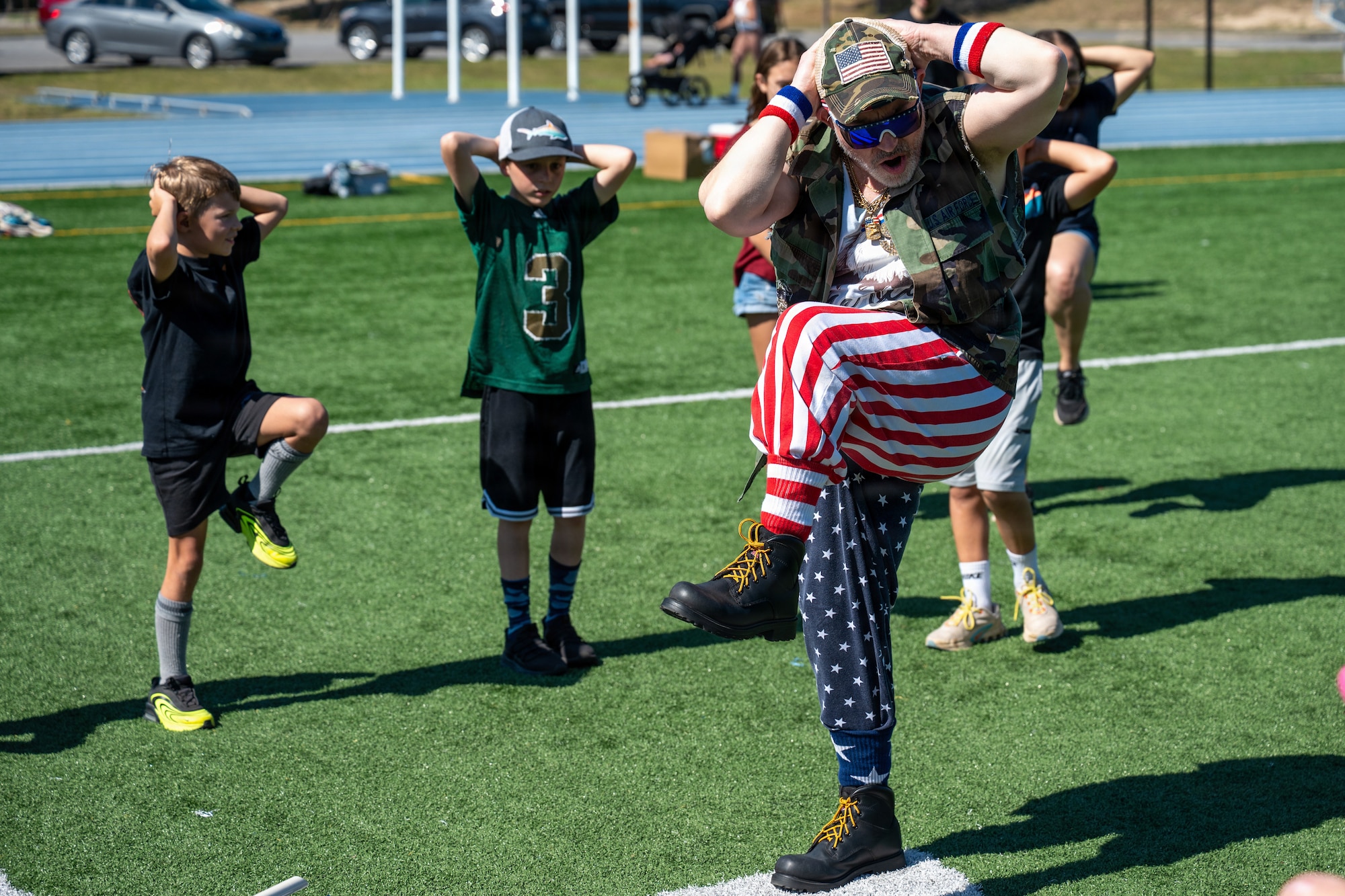 A 1st Special Operations Wing health promotion coordinator leads a physical training session for military children during Operation Discovering and Exploring Military Operations at Hurlburt Field, Florida, April 11, 2026.