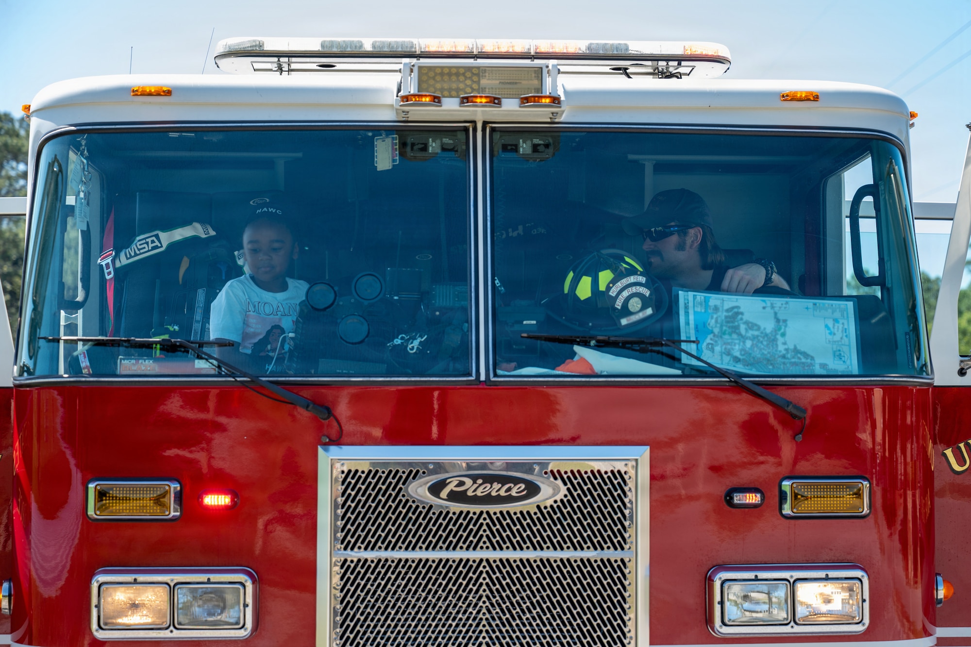 A 1st Special Operations Wing firefighter shows a child the inside of a fire truck during Operation Discovering and Exploring Military Operations at Hurlburt Field, Florida, April 11, 2026.