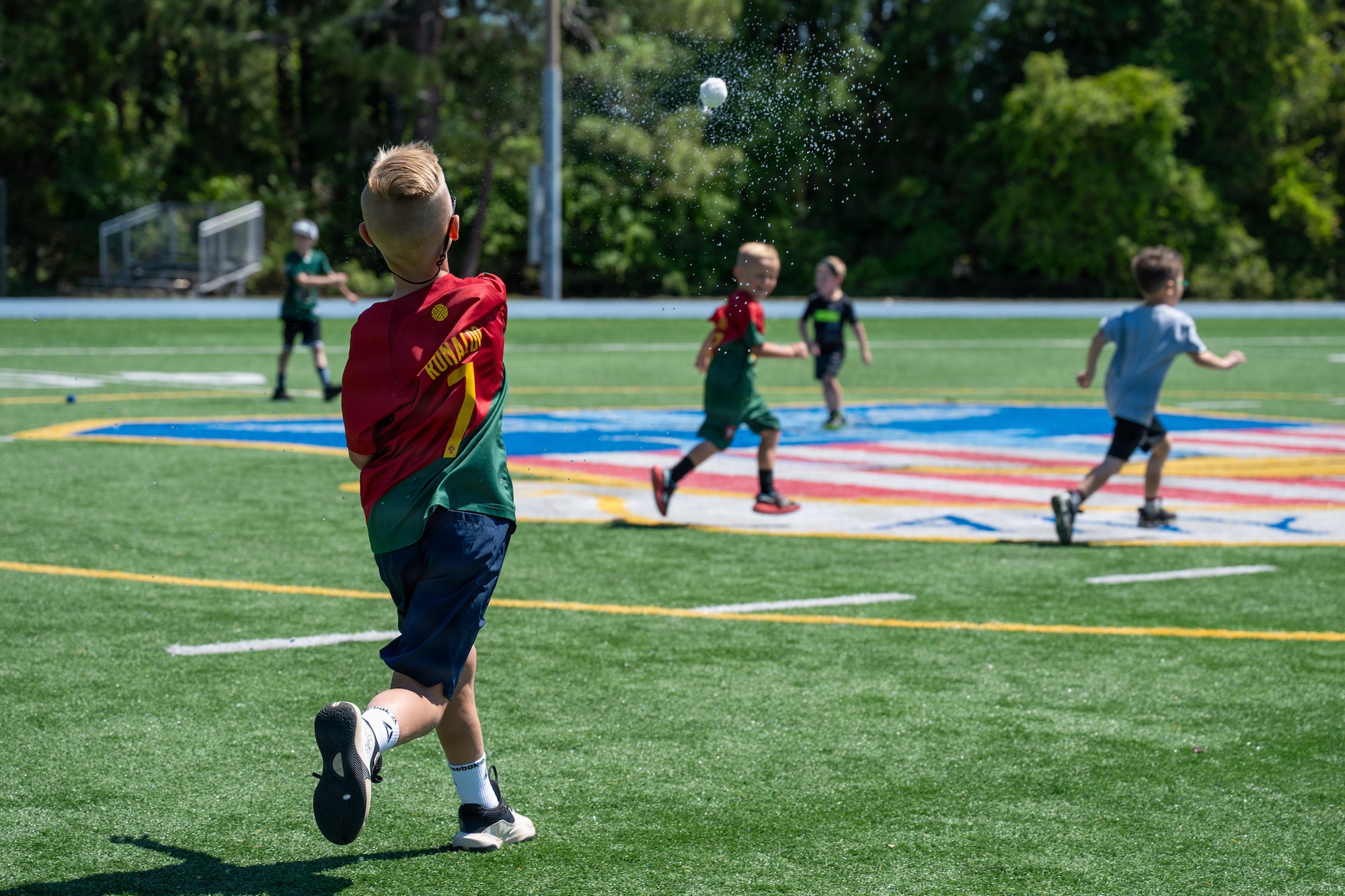 Military children throw reusable water toys during Operation Discovering and Exploring Military Operations at Hurlburt Field, Florida, April 11, 2026.