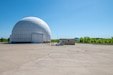 A portion of Tobyhanna Army Depot's radar testing campus - one white domed structure in the foreground and one more in the distance are seen.