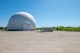 A portion of Tobyhanna Army Depot's radar testing campus - one white domed structure in the foreground and one more in the distance are seen.