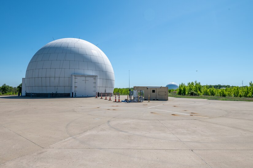 A portion of Tobyhanna Army Depot's radar testing campus - one white domed structure in the foreground and one more in the distance are seen.