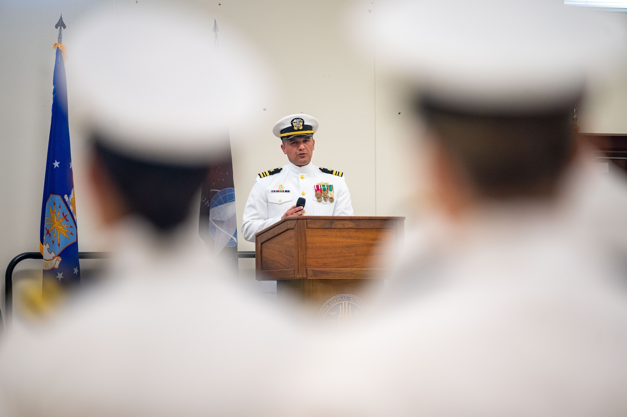 Lieutenant Commander Lazaro Cardenas, Navy Reserve Center Albuquerque commander, gives remarks during a change of command ceremony at Kirtland Air Force Base, N. M., June 7, 2026. During the ceremony, LCDR Cardenas relieved Commander Nicholas Bularzik, outgoing NRC Albuquerque commander, of his duties. LCDR Cardenas will oversee more than 175 Navy Reserve Sailors to support the Navy and Marine Corps team across a full spectrum of military operations. (U.S. Air Force photo by Tech. Sgt. Gabrielle Winn)
