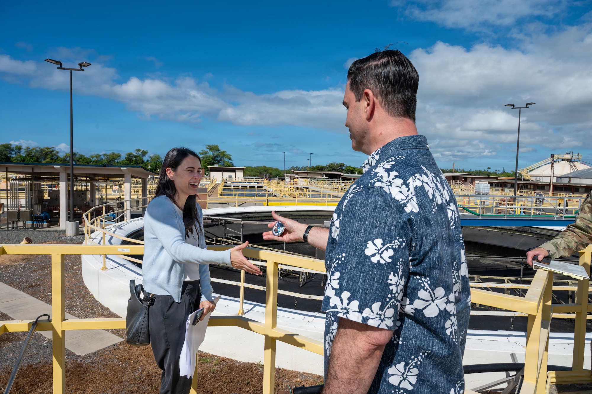 The Honorable Michael Borders, U.S. Assistant Secretary of the Air Force for Energy, Installations and Environment, recognizes Rochelle Penney, Utilities Management Division Director, for superior performance while touring Joint Base Pearl Harbor-Hickam.