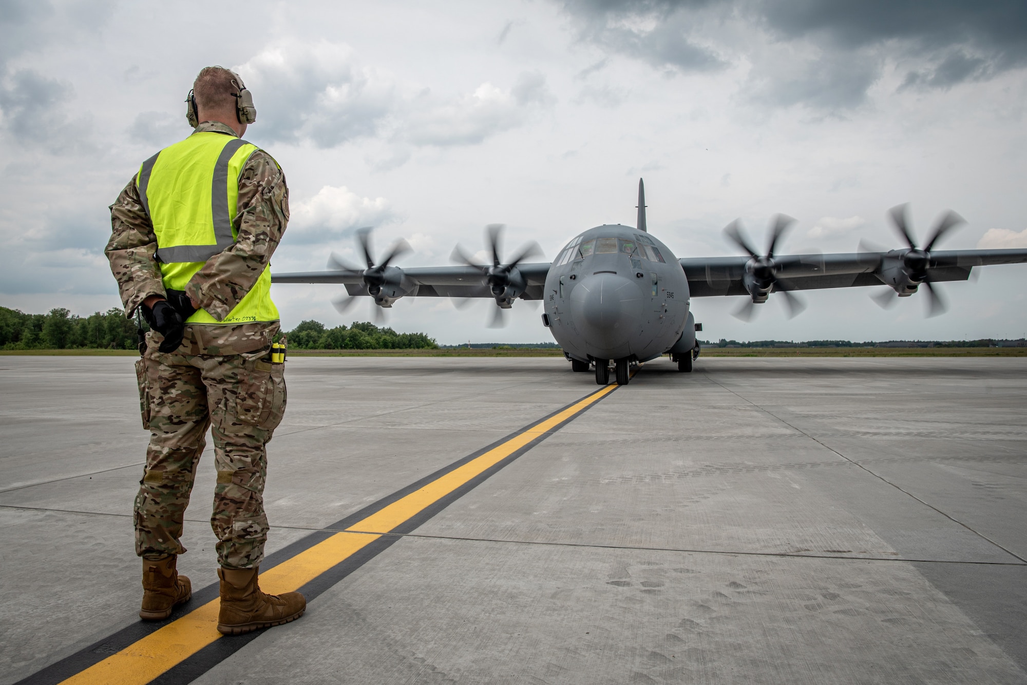 A crew chief assigned to the 123rd Airlift Wing, Kentucky Air National Guard, marshals a U.S. Air Force C-130J Super Hercules aircraft on the flight line at Karup Air Base, Denmark, June 2, 2026. The 123rd AW is providing tactical airlift support to NATO Allies throughout the month of June in support of Ramstein Flag 2026, an Allied Air Command large-scale, air-focused, multi-location and joint operating area exercise with 18 participating nations and more than 200 aircraft. (U.S. Air National Guard photo by Master Sgt. Joshua Horton)