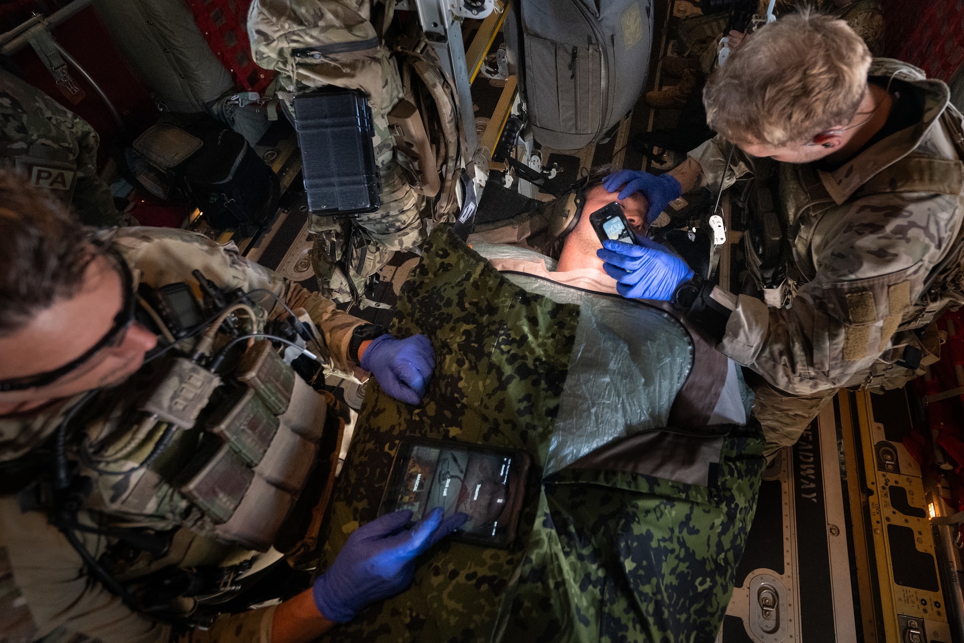 Members of a Danish Armed Forces Air Mobile Protection and Recovery team provide medical care to a simulated patient as part of an aeromedical evacuation exercise while flying in the skies of Denmark aboard a U.S. Air Force C-130J Super Hercules aircraft assigned to the 123rd Airlift Wing, Kentucky Air National Guard, June 4, 2026. The 123rd AW is providing tactical airlift support to NATO Allies throughout the month of June in support of Ramstein Flag 2026, an Allied Air Command large-scale, air-focused, multi-location and joint operating area exercise that kicks off June 8 with 18 participating nations and more than 200 aircraft. (U.S. Air National Guard photo by Lt. Col. Dale Greer)