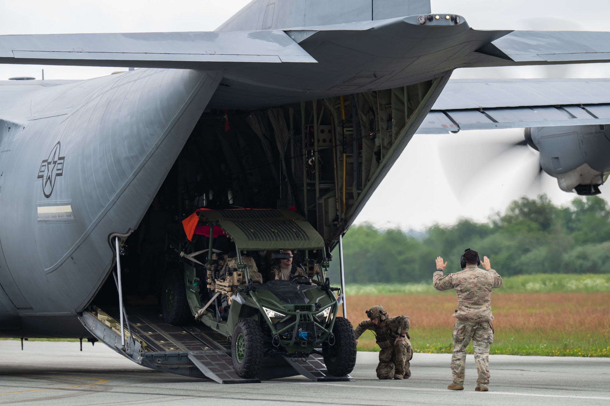 A U.S. Air Force loadmaster with the 123rd Airlift Wing, Kentucky Air National Guard, directs the onloading of a tactical vehicle onto a C-130J Super Hercules aircraft at Sindal Airport in Sindal, Denmark, June 3, 2026, as part of a personnel search-and-recovery training scenario conducted with the Danish Armed Forces. The 123rd AW is providing tactical airlift support to NATO Allies throughout the month of June in support of Ramstein Flag 2026, an Allied Air Command large-scale, air-focused, multi-location and joint operating area exercise with 18 participating nations and more than 200 aircraft. (U.S. Air National Guard photo by Lt. Col. Dale Greer)