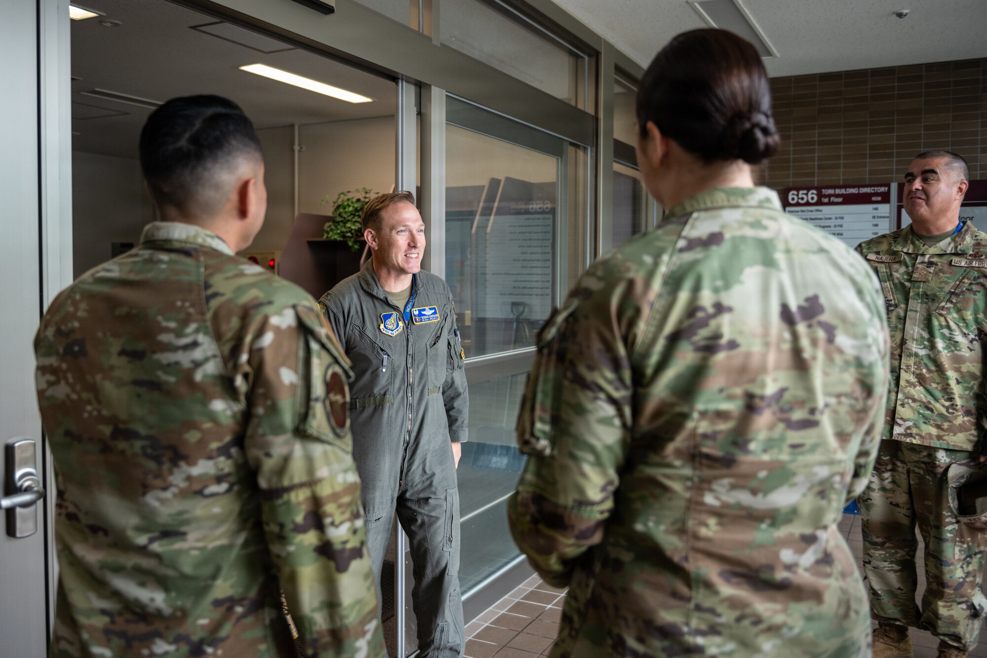 U.S. Air Force Col. Paul Davidson, 35th Fighter Wing (FW) commander, center, greets Airmen assigned to the 35th Contracting Squadron (CONS) during a Wild Weasel Walk-Through.