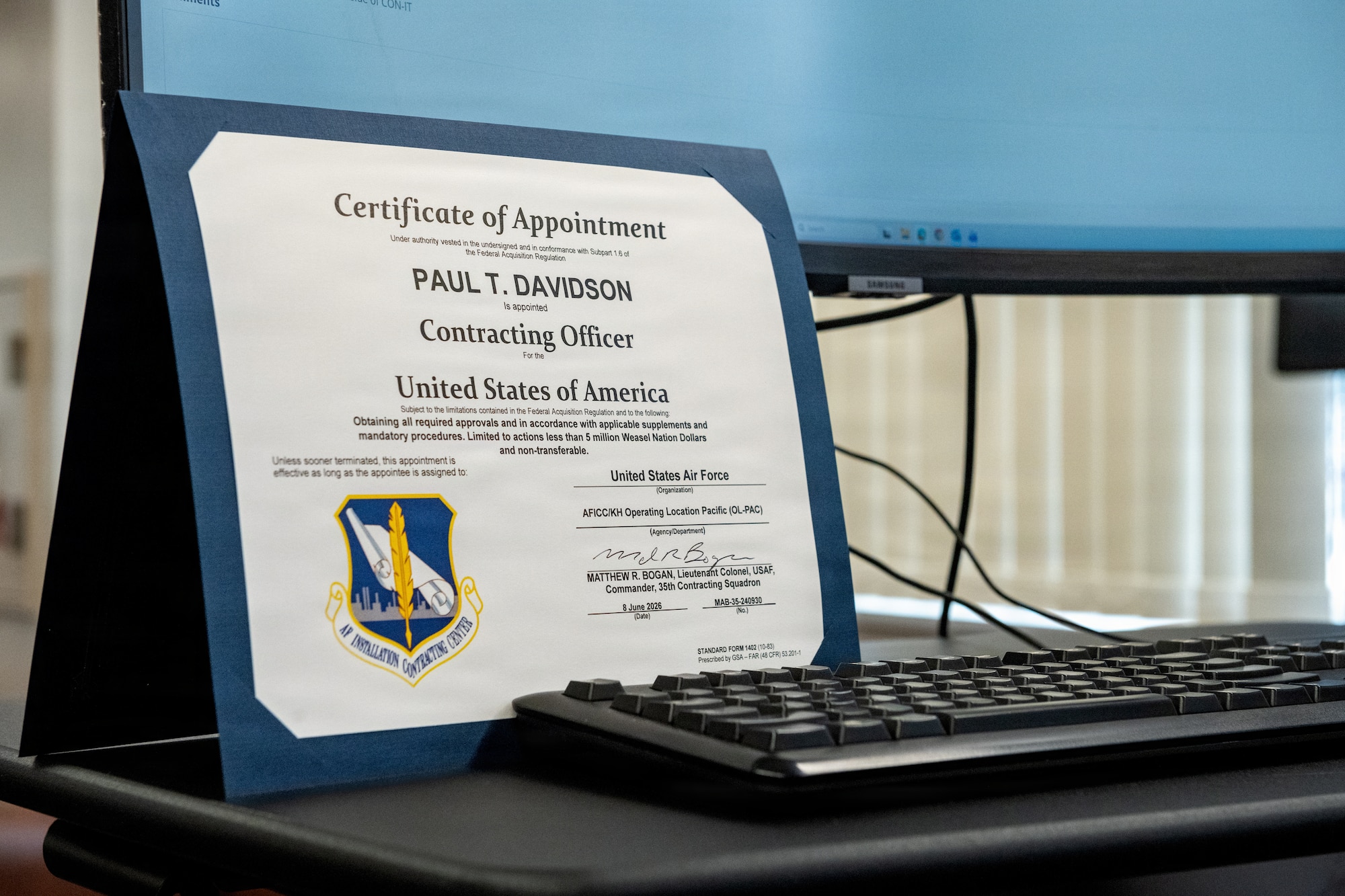 An imitation contracting officer appointment certificate for U.S. Air Force Col. Paul Davidson, 35th Fighter Wing commander, is displayed during a Wild Weasel Walk-Through.