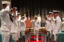 260604-N-MZ309-1218 KEYPORT, Wash. (June 4, 2026) Rear Adm. Chris Nash, commander of Submarine Group (SUBGRU) 9, departs a change of command ceremony at the U.S. Naval Undersea Museum in Keyport, Washington, June 4, 2026. During the ceremony Capt. Lacy Lodmell relieved Capt. Rob Garis as commodore of Submarine Squadron (CSS) 19. CSS-19 is subordinate to Commander, Submarine Group (SUBGRU) 9 which exercises administrative and operational control of assigned submarine commands and units in the Pacific Northwest, providing oversight for shipboard training, personnel, and the supply and material readiness of SSBNs and their crews. SUBGRU-9 is also responsible for nuclear submarines undergoing conversion or overhaul at Puget Sound Naval Shipyard in Bremerton. (U.S. Navy photo by Mass Communication Specialist 1st Class Ryan Riley)