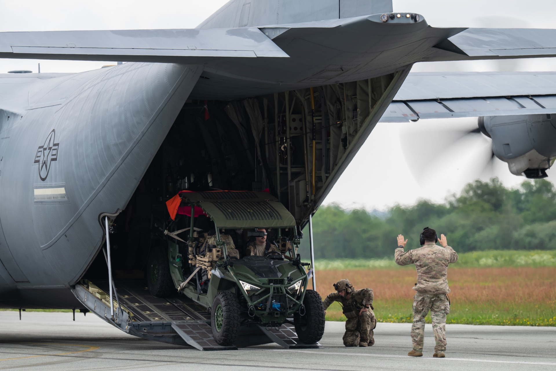 A U.S. Air Force loadmaster with the 123rd Airlift Wing, Kentucky Air National Guard, directs the onloading of a tactical vehicle onto a C-130J Super Hercules aircraft at Sindal Airport in Sindal, Denmark, June 3, 2026, as part of a personnel search-and-recovery training scenario conducted with the Danish Armed Forces. The 123rd AW is providing tactical airlift support to NATO Allies throughout the month of June in support of Ramstein Flag 2026, an Allied Air Command large-scale, air-focused, multi-location and joint operating area exercise with 18 participating nations and more than 200 aircraft. (U.S. Air National Guard photo by Lt. Col. Dale Greer)