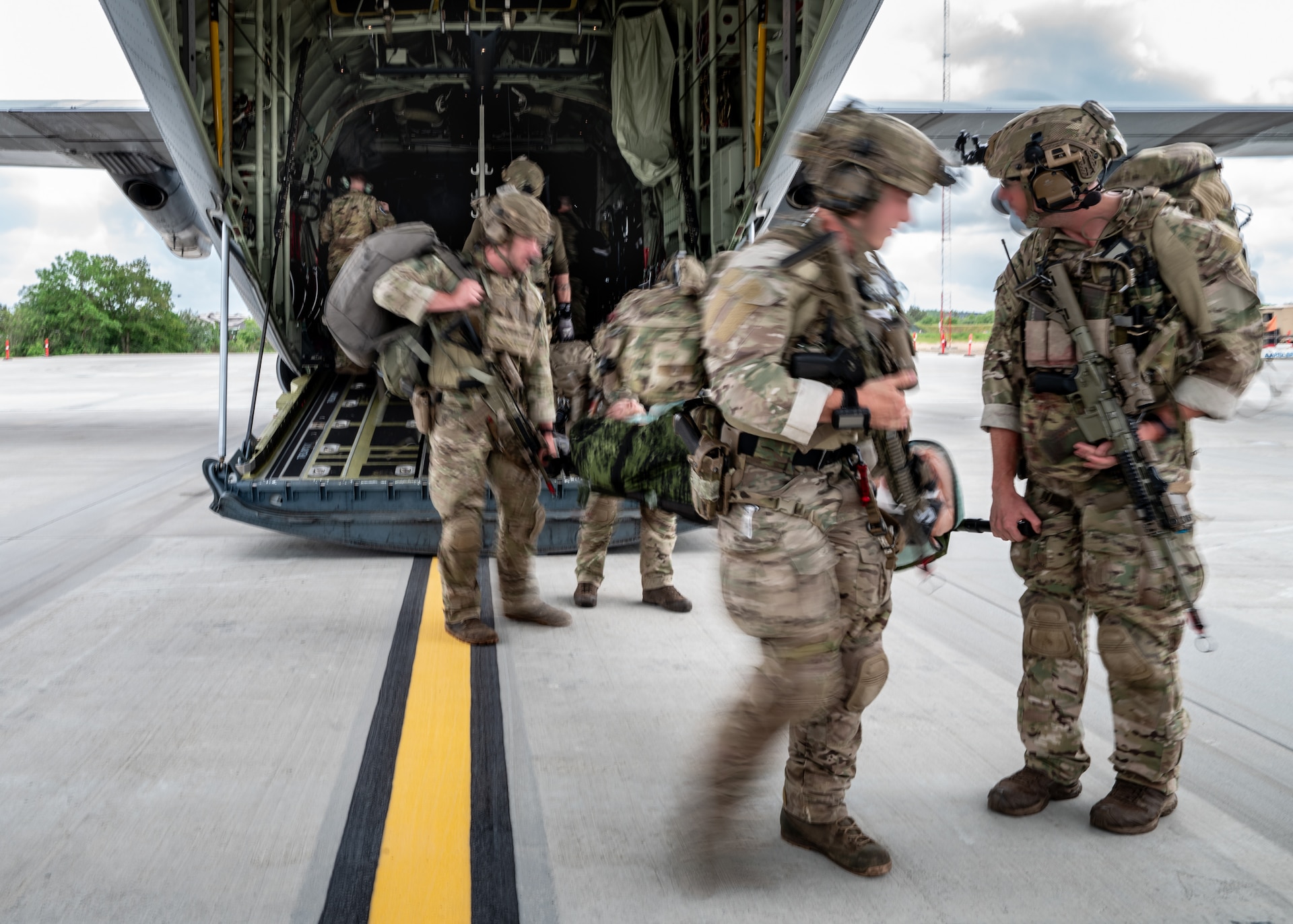 An Air Mobility Personnel Recovery team from the Danish Armed Forces carries a litter with a simulated medical patient from a U.S. Air Force C-130J Super Hercules aircraft assigned to the 123rd Airlift Wing, Kentucky Air National Guard, at Karup Air Base, Denmark, June 4, 2026. The 123rd AW is providing tactical airlift support to NATO Allies throughout the month of June in support of Ramstein Flag 2026, an Allied Air Command large-scale, air-focused, multi-location and joint operating area exercise that kicks off June 8 with 18 participating nations and more than 200 aircraft. (U.S. Air National Guard photo by Lt. Col. Dale Greer)