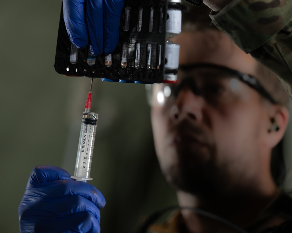 A medic with the Danish Armed Services prepares a syringe during an aeromedical evacuation exercise aboard a U.S. Air Force C-130J Super Hercules aircraft assigned to the 123rd Airlift Wing, Kentucky Air National Guard, while flying over Denmark on June 4, 2026. The 123rd AW is providing tactical airlift support to NATO Allies throughout the month of June in support of Ramstein Flag 2026, an Allied Air Command large-scale, air-focused, multi-location and joint operating area exercise that kicks off June 8 with 18 participating nations and more than 200 aircraft. (U.S. Air National Guard photo by Lt. Col. Dale Greer)