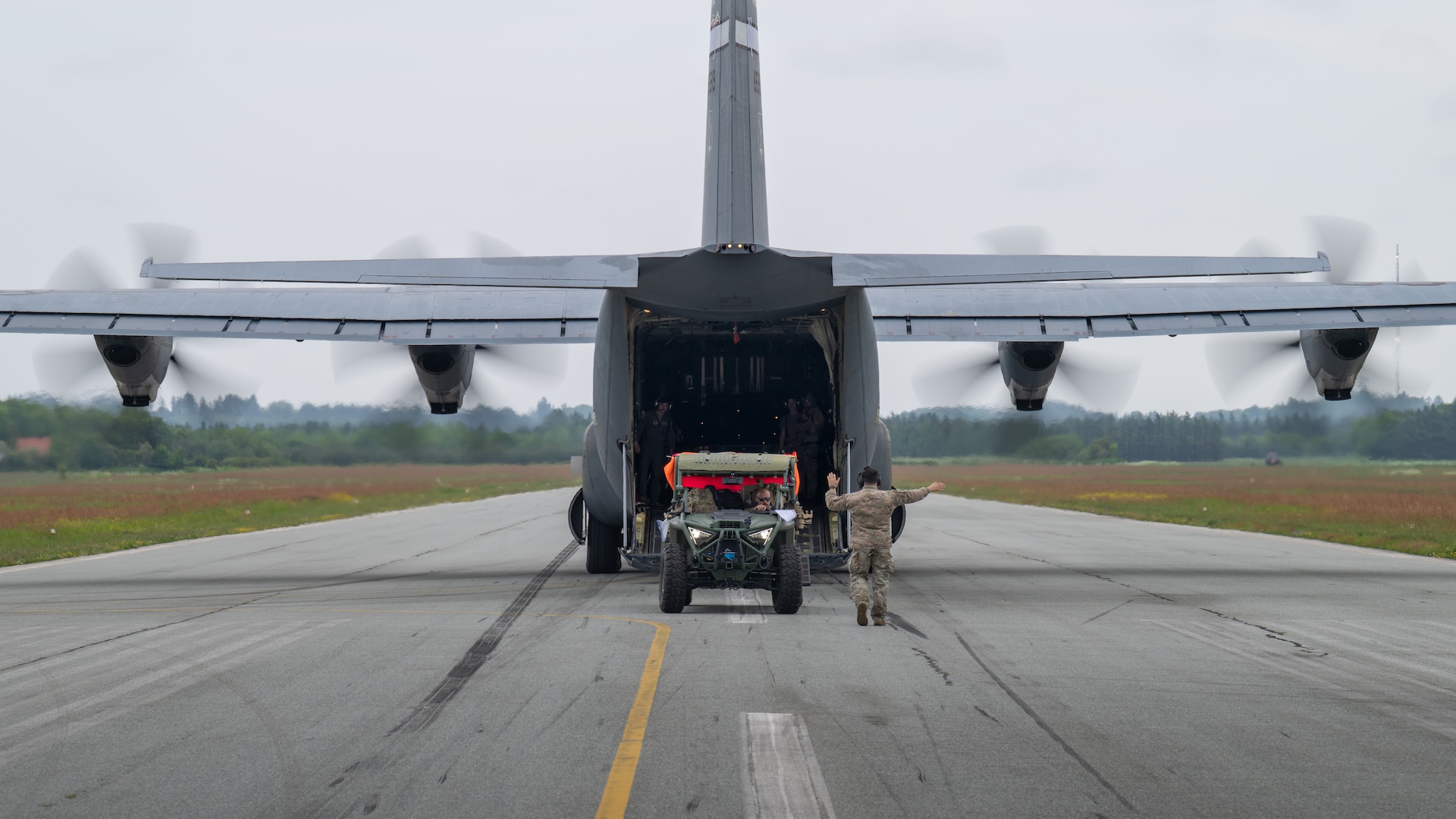 A U.S. Air Force loadmaster with the 123rd Airlift Wing, Kentucky Air National Guard, directs the onloading of a tactical vehicle onto a C-130J Super Hercules aircraft at Sindal Airport in Sindal, Denmark, June 3, 2026, as part of a personnel search-and-recovery training scenario conducted with the Danish Armed Forces. The 123rd AW is providing tactical airlift support to NATO Allies throughout the month of June in support of Ramstein Flag 2026, an Allied Air Command large-scale, air-focused, multi-location and joint operating area exercise with 18 participating nations and more than 200 aircraft. (U.S. Air National Guard photo by Lt. Col. Dale Greer)