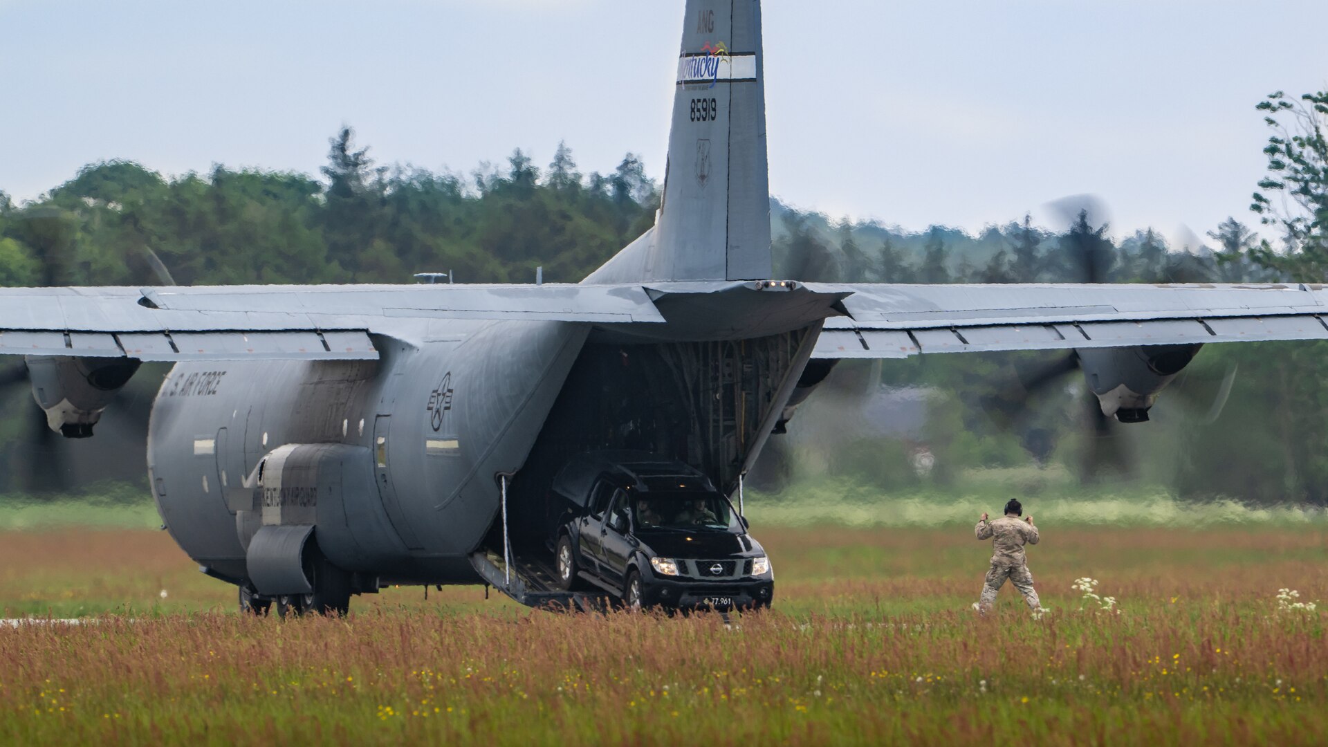 A U.S. Air Force loadmaster with the 123rd Airlift Wing, Kentucky Air National Guard, guides members of a Danish Armed Forces Air Mobility Personnel Recovery team as they drive off a U.S. Air Force C-130J Super Hercules aircraft at Sindal Airport in Sindal, Denmark, June 3, 2026, as part of a search-and-recovery training scenario. The 123rd AW is providing tactical airlift support to NATO Allies throughout the month of June in support of Ramstein Flag 2026, an Allied Air Command large-scale, air-focused, multi-location and joint operating area exercise with 18 participating nations and more than 200 aircraft. (U.S. Air National Guard photo by Lt. Col. Dale Greer)