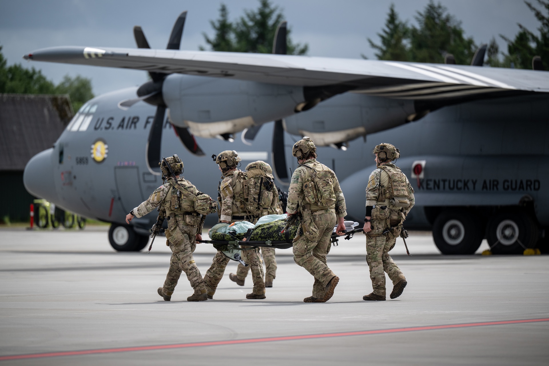 An Air Mobility Personnel Recovery team from the Danish Armed Forces carries a litter with a simulated medical patient from a U.S. Air Force C-130J Super Hercules aircraft assigned to the 123rd Airlift Wing, Kentucky Air National Guard, at Karup Air Base, Denmark, June 4, 2026. The 123rd AW is providing tactical airlift support to NATO Allies throughout the month of June in support of Ramstein Flag 2026, an Allied Air Command large-scale, air-focused, multi-location and joint operating area exercise that kicks off June 8 with 18 participating nations and more than 200 aircraft. (U.S. Air National Guard photo by Lt. Col. Dale Greer)