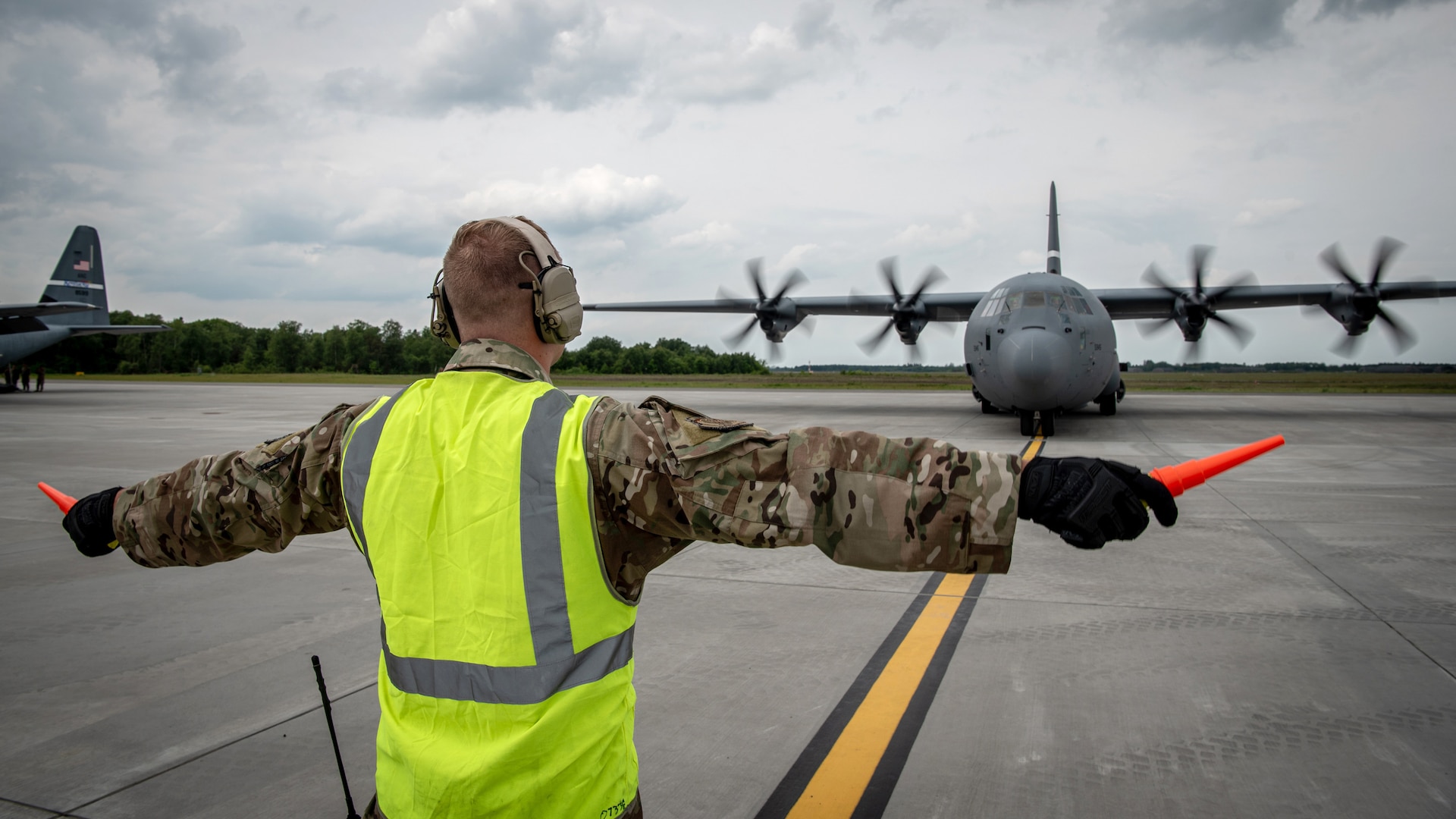 A crew chief assigned to the 123rd Airlift Wing, Kentucky Air National Guard, marshals a U.S. Air Force C-130J Super Hercules aircraft on the flight line at Karup Air Base, Denmark, June 2, 2026. The 123rd AW is providing tactical airlift support to NATO Allies throughout the month of June in support of Ramstein Flag 2026, an Allied Air Command large-scale, air-focused, multi-location and joint operating area exercise with 18 participating nations and more than 200 aircraft. (U.S. Air National Guard photo by Master Sgt. Joshua Horton)