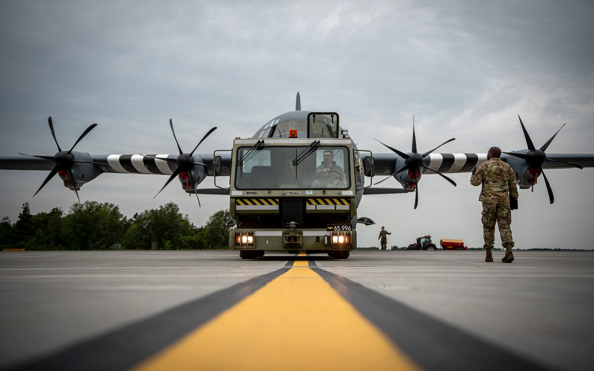 U.S. Airmen with the 123rd Airlift Wing, Kentucky Air National Guard, reposition a C-130J Super Hercules aircraft using a tow tractor on the flight line at Karup Air Base, Denmark, June 2, 2026. The 123rd AW is providing tactical airlift support to NATO Allies throughout the month of June in support of Ramstein Flag 2026, an Allied Air Command large-scale, air-focused, multi-location and joint operating area exercise with 18 participating nations and more than 200 aircraft. (U.S. Air National Guard photo by Master Sgt. Joshua Horton)