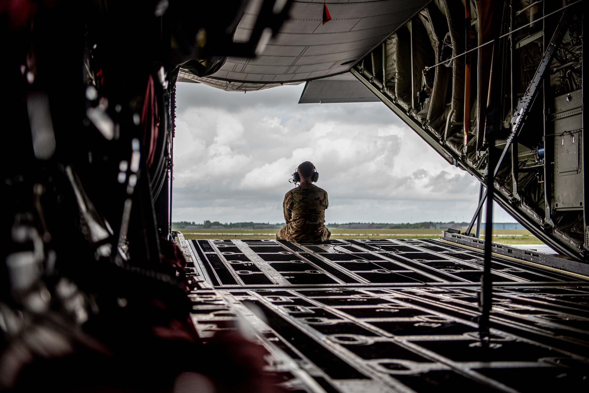 A loadmaster with the 123rd Airlift Wing, Kentucky Air National Guard, sits on the ramp of a U.S. Air Force C-130J Super Hercules aircraft at Karup Air Base, Denmark, June 4, 2026. The 123rd AW is providing tactical airlift support to NATO Allies throughout the month of June as part of Ramstein Flag 2026, an Allied Air Command large-scale, air-focused, multi-location and joint operating area exercise that kicks off June 8 with 18 participating nations and more than 200 aircraft. (U.S. Air National Guard photo by Master Sgt. Joshua Horton)