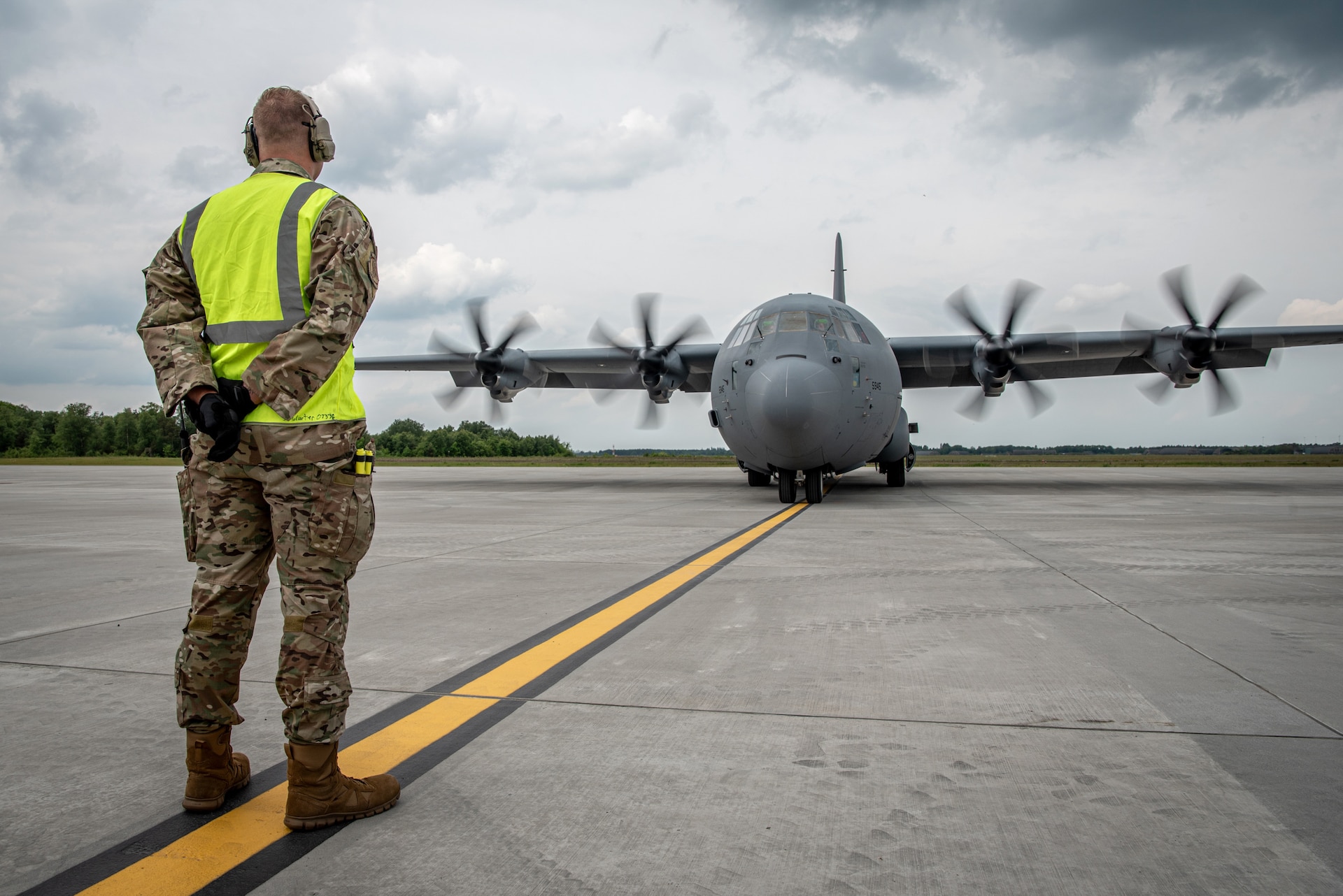 A crew chief assigned to the 123rd Airlift Wing, Kentucky Air National Guard, marshals a U.S. Air Force C-130J Super Hercules aircraft on the flight line at Karup Air Base, Denmark, June 2, 2026. The 123rd AW is providing tactical airlift support to NATO Allies throughout the month of June in support of Ramstein Flag 2026, an Allied Air Command large-scale, air-focused, multi-location and joint operating area exercise with 18 participating nations and more than 200 aircraft. (U.S. Air National Guard photo by Master Sgt. Joshua Horton)
