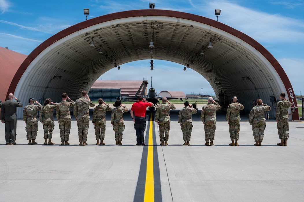 Airmen salute commander.