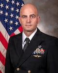 Navy Lt. j.g. Drew Murray, a nurse assigned to U.S. Naval Hospital (USNH) Guam, poses for an official photo. Murray recently earned recognition as a recipient of the 2025 Military health System (MHS) Nursing Leadership Excellence Award in the junior military category.