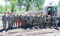 Soldiers assigned to Detachment 1, 230th Engineer Company pose for a group photo during a community construction project at Legion Park in Culbertson, Montana, June 2026.
