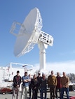 Installation and Logistics Team Members from L3 Harris and Systems Delta 81 (SYD 81) assemble as a group after inventorying and deploying the antenna system in just four days, 1Q CY 26. (U.S. Navy photo)