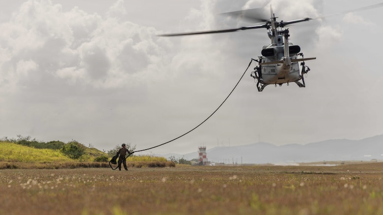 A U.S. Marine with Lima Company, 3rd Battalion, 2nd Marine Regiment, Littoral Combat Force-24, grabs the fast-rope during a long range fast-rope rehearsal from a UH-1Y Venom with Marine Medium Tiltrotor Squadron (VMM) 365 (Reinforced), LCF-24, at Naval Station Guantanamo Bay, Cuba, June 4, 2026. U.S. military forces are deployed to the U.S. Southern Command area of responsibility in support of Operation SOUTHERN SPEAR, Department of War-directed operations, and the president’s priorities to disrupt illicit drug trafficking, deter malign actors and protect the homeland through continuous presence. (U.S. Marine Corps photo)