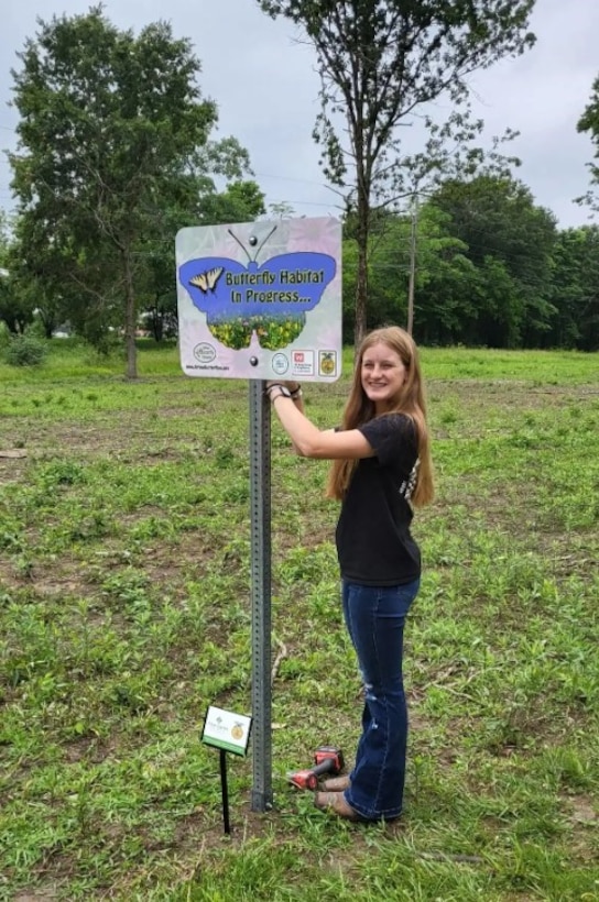 Partner helps install sign at the new Shelbyville Pollinator area