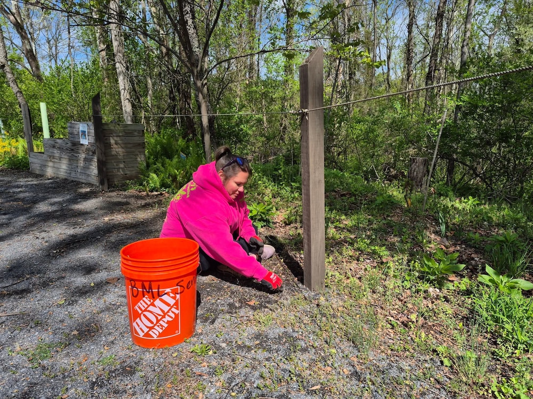 A volunteer helps with trail maintenance