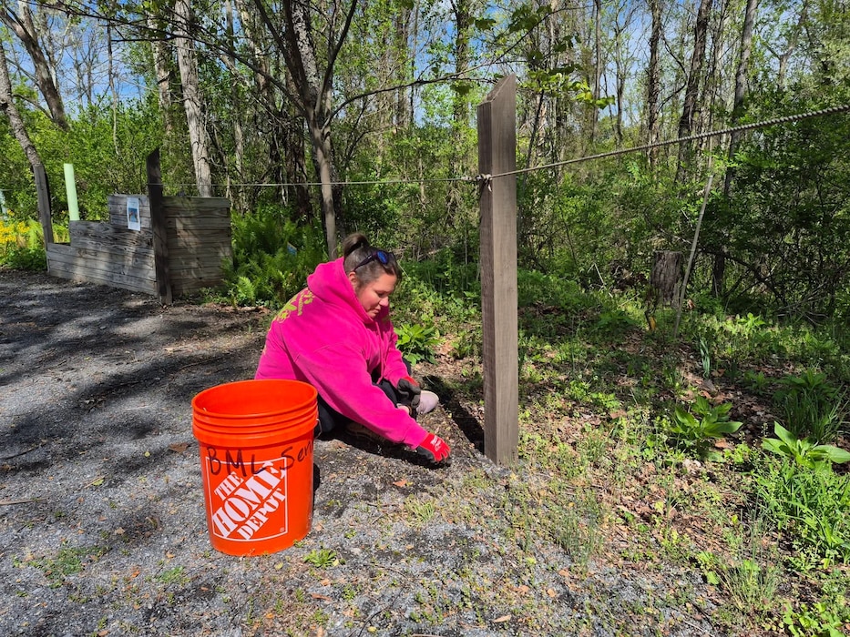 A volunteer helps with trail maintenance